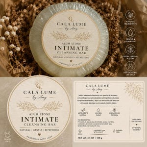 May include: A round, translucent alum stone intimate cleansing bar by Cala Lume by Amy. The label features the text 'ALUM STONE INTIMATE CLEANSING BAR' and 'NATURAL GENTLE REFRESHING'. The product is 100 grams and includes natural ingredients.