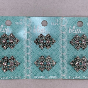Six Small Nouveau Style Two-Piece Silvertone & Crystal Buckles on Original Cards
