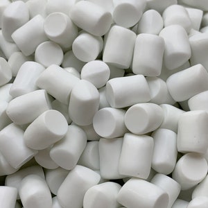 May include: A close-up image of a pile of white, round, and slightly elongated marshmallows.
