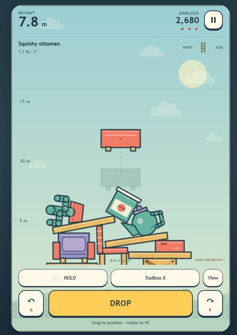 May include: A digital game interface showing a stack of various household objects including a purple chair, a teal teapot, and a paint bucket. A red squishy ottoman is suspended above the pile. The screen displays height, score, and control buttons.