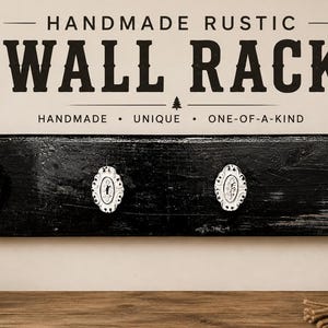 May include: A black rectangular wooden wall rack featuring four white oval decorative knobs. The text above reads HANDMADE RUSTIC WALL RACK, HANDMADE UNIQUE ONE-OF-A-KIND. A small sign in the corner displays the text LIVE SIMPLY ADVENTURE OFTEN.