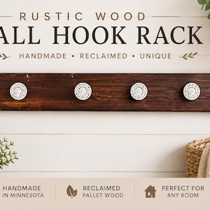 May include: A dark brown wooden wall hook rack featuring four circular white knobs with intricate black patterns. The text RUSTIC WOOD WALL HOOK RACK is printed above the rack, with additional text including HANDMADE, RECLAIMED, UNIQUE, HANDMADE IN MINNESOTA, RECLAIMED PALLET WOOD, and PERFECT FOR ANY ROOM.