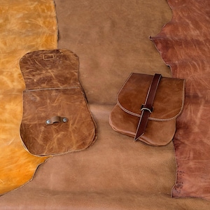 Brown leather hide color range: orange/yellow brown, soft medium-tan brown, red brown. The original batch colors are layed on top of the current hides, these colors are no longer available.