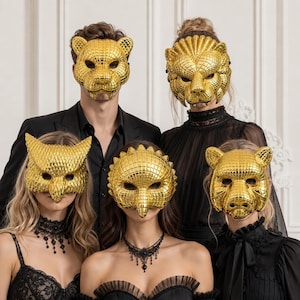 May include: Five individuals wearing reflective gold animal masks with a textured grid pattern. The masks depict a tiger, a lion, an owl, a bird, and a bear. The individuals are dressed in black clothing, including lace and collared shirts.