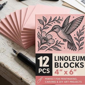 May include: A stack of twelve pink linoleum blocks for printmaking, each measuring 4 inches by 6 inches. The top block features a black ink illustration of a hummingbird hovering near a flower. A black carving tool is positioned nearby.