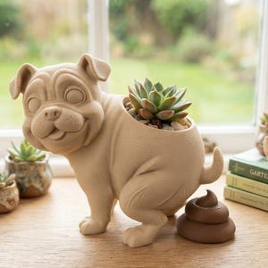 May include: A light beige pug-shaped planter with a succulent planted in its back. The pug is in a squatting position with a brown, coiled, poop-shaped object placed directly behind it. The planter has a smooth, matte finish and a cartoonish design.