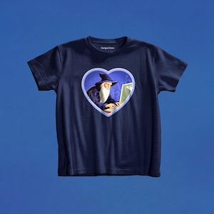 May include: A navy blue short-sleeved t-shirt featuring a central heart-shaped graphic. Inside the heart, a wizard with a long white beard and a dark blue pointed hat is typing on a computer. The brand name Marigai Maria is printed on the inner neck.