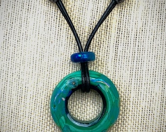 Iridescent Lampwork Disc Necklace on Adjustable Black Leather Cord in Shades of Blue and Green Silver Glass.