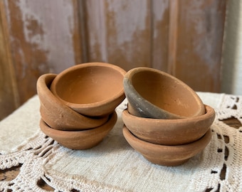 A set of 6 unglazed terracotta mini/seedling pots.