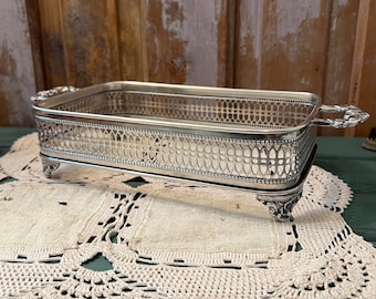 A vintage silver-plated casserole dish holder or serving tray caddy