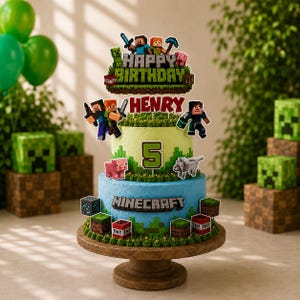 May include: A two-tiered cake decorated with Minecraft-themed toppers. The top tier is light green, the bottom is blue, both featuring pixelated characters, TNT blocks, and grass accents. The cake displays the text Happy Birthday, Henry, and 5.