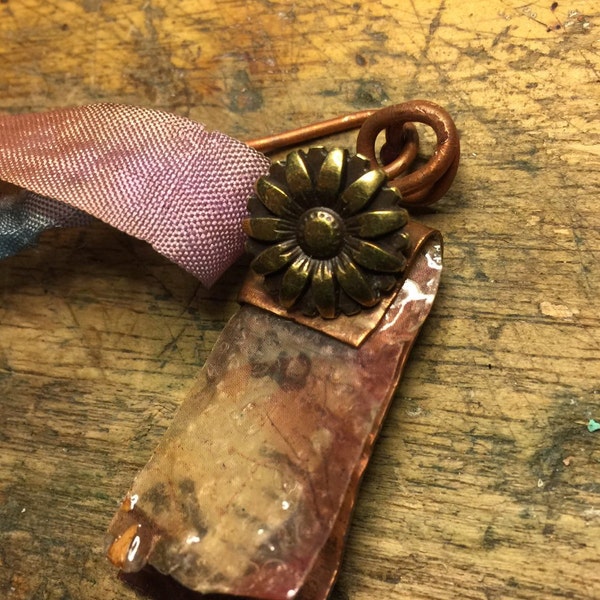 Assemblage book necklace, copper with resin pages, ooak measuring tape, and vintage components.