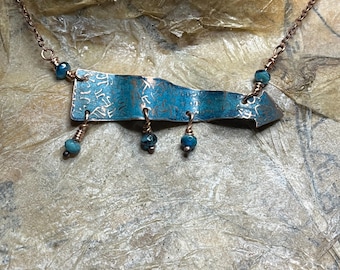 I’m with them arrow necklace, in copper with dark blue and green patina and blue Picasso beads