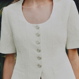 Ecru Jacquard Short Sleeve Jacket | Round Neck Tab Button Detail | False Welt Pocket Front Button Jacket | Womens Structured UK