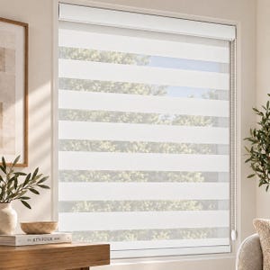 May include: A white dual-layer roller shade installed over a window, featuring alternating horizontal bands of opaque fabric and sheer mesh. The shade includes a white top cassette housing and a white beaded chain mechanism for adjusting light levels.