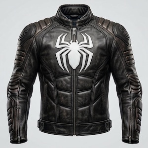 May include: A dark brown leather motorcycle jacket featuring a prominent white spider emblem on the chest. The jacket includes a stand-up collar, a full-length front zipper, padded shoulder and elbow sections, and ribbed detailing on the sleeves.