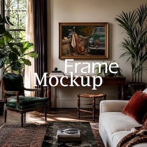 May include: A rectangular wooden picture frame containing a painting of a green vintage car and a leather golf bag resting against a stone wall. The frame is mounted on a light-colored wall above a dark wooden console table in a furnished room.