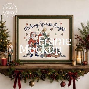 May include: A rectangular picture frame with a dark green border containing a print of Santa Claus decorating a Christmas tree with the text "Making Spirits Bright". The frame is displayed on a wooden mantelpiece with holiday decor.