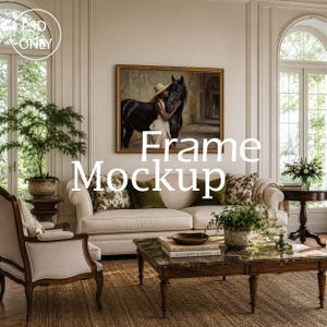 May include: A rectangular gold-toned picture frame mockup featuring a painting of a person in a hat standing beside a black horse. The frame is displayed on a light-colored wall above a cream-colored sofa with green and patterned throw pillows.