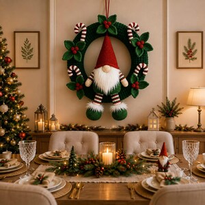 May include: A dark green crocheted wreath featuring a central gnome with a red hat and white beard, decorated with red and white candy canes and green holly leaves with red berries. The wreath is hung on a wall above a dining table setting.