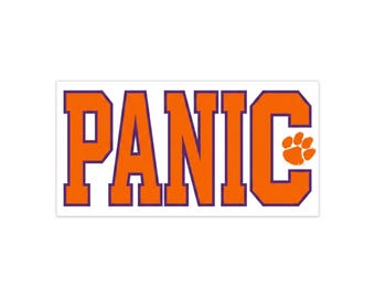 May include: A rectangular sticker featuring the word PANIC in bold, orange, block-style letters with a thin purple outline. The letter C incorporates an orange tiger paw print design within its structure against a plain white background.
