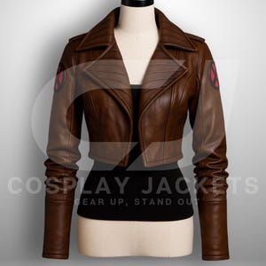 May include: A cropped brown leather jacket featuring wide lapels, long sleeves, and circular red and black X-Men logos on each shoulder. The jacket is displayed on a mannequin over a black top, with the text COSPLAY JACKETS GEAR UP, STAND OUT.