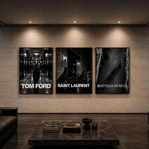 May include: Three rectangular wall art prints in black frames featuring black and white photography. The left print displays a hallway with the text TOM FORD, the center shows a street scene with SAINT LAURENT, and the right shows a boat with BOTTEGA VENETA.