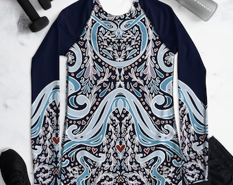 May include: A navy blue long-sleeved shirt with a white and blue patterned design. The pattern features stylised floral motifs, swirls, and hearts.