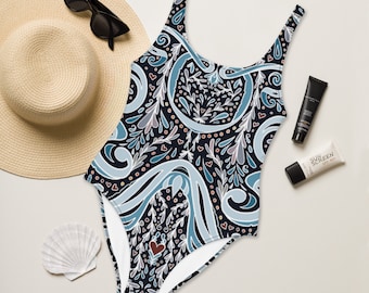May include: A navy blue swimsuit with a white, blue and pink floral pattern. The swimsuit has a scoop neck and a low back.