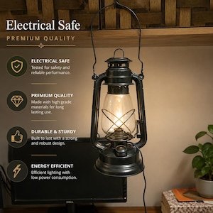 May include: A black metal lantern with a clear glass globe and a wire handle, emitting a warm light. The text on the left reads: Electrical Safe, Premium Quality, Electrical Safe Tested for safety, Premium Quality, Durable & Sturdy, Energy Efficient.