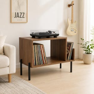 May include: A walnut-finished wooden record player stand with four black metal legs, featuring an open storage compartment filled with vinyl records and a black turntable with a clear plastic dust cover placed on the top surface.
