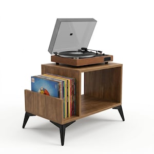May include: A wooden record player stand with a walnut finish and black angled legs. The stand features a side compartment filled with vinyl records and a top surface holding a black turntable with a clear dust cover and silver accents.