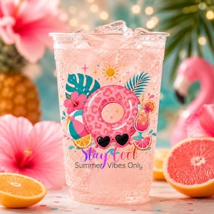 May include: A clear plastic cup filled with a pink iced beverage, featuring a colorful graphic of a leopard print pool float, heart-shaped sunglasses, a tropical drink, and hibiscus flowers. The text reads Stay cool Summer Vibes Only.