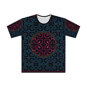 May include: A short-sleeve t-shirt featuring a black base with a repeating geometric pattern in cyan blue lines. A large central circle contains a complex, symmetrical design in magenta and orange, surrounded by a thin, decorative border.