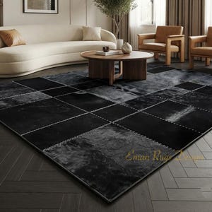 May include: A large rectangular area rug featuring a patchwork design of black and dark gray hide panels. The rug is constructed with visible light-colored stitching between each square section. The text Eman Rugs Design is visible.