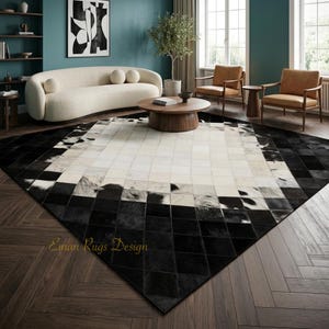 May include: A large area rug featuring a geometric patchwork design made of square tiles in contrasting black, white, and mottled gray tones. The rug displays a diamond-shaped pattern with the text Eiman Rugs Design printed in gold.