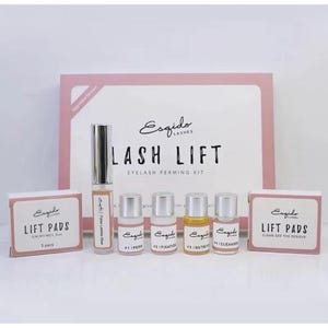 May include: An Esqido Lashes lift kit featuring a large pink and white box labelled LASH LIFT, a tube of false lashes glue, four small bottles labelled #1 Perm, #2 Fixation, #3 Nutrition, and #4 Cleanser, and two boxes labelled Lift Pads.