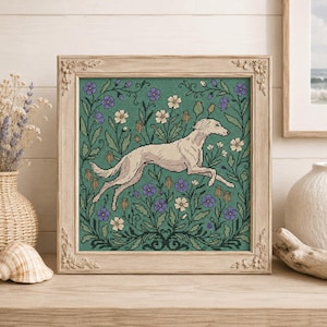 May include: A square framed cross-stitch embroidery featuring a light-colored sighthound dog leaping through a field of green foliage, purple flowers, and white blossoms. The piece is encased in a light-toned wooden frame with floral carvings.