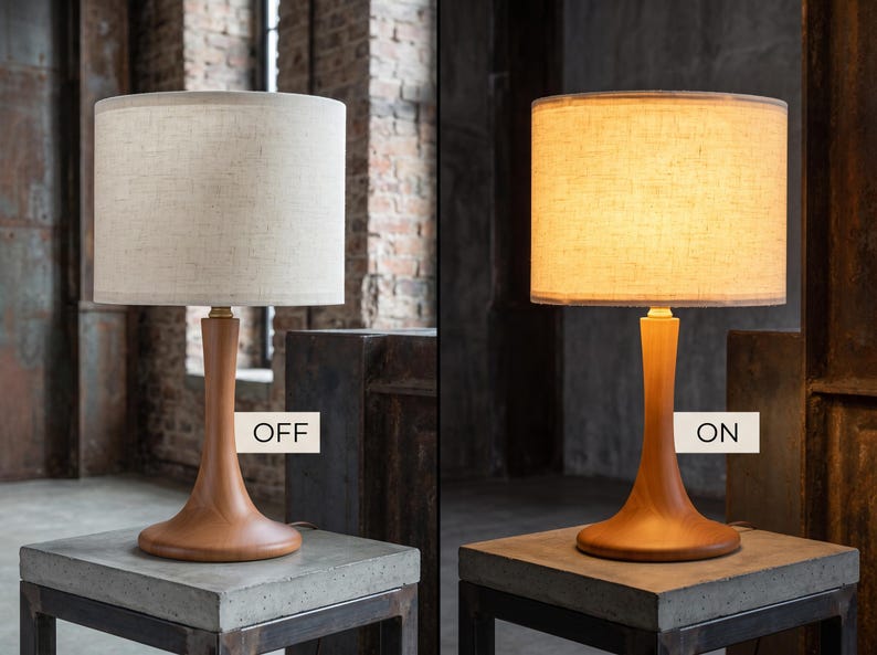 May include: A table lamp with a smooth, light brown wooden base and a cylindrical, textured off-white fabric shade. The image displays the lamp in two states: one labeled OFF with the light unlit, and one labeled ON with the light illuminated.