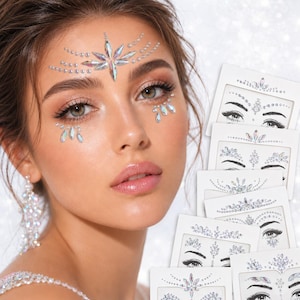 May include: A set of adhesive face gems featuring iridescent, clear, and diamond-shaped crystals arranged in intricate patterns. The collection includes multiple white backing cards displaying various designs of forehead and eye area stickers.