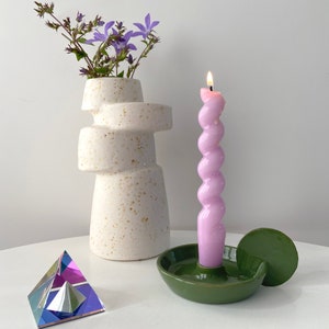 Handmade candleholder with disc shaped handle glazed in a bright bottle green. The shape of this candleholder is minimalistic and looks great in a Scandinavian style interior. The colour is a nice touch to add to your colourful style.