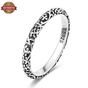 May include: A silver ring featuring an intricate, raised vine-like pattern with oxidised dark recessed areas for contrast. The inner band is clearly stamped with the text S925, indicating the metal composition of this thin, circular jewellery piece.
