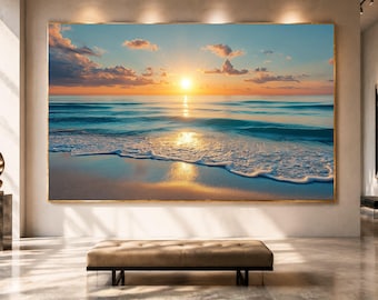 May include: A large rectangular wall art print featuring a vibrant sunset over a calm ocean. The scene displays a golden sun low on the horizon, soft clouds in a blue and orange sky, and gentle waves washing onto a sandy beach with light reflections.