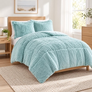 May include: A light teal, plush, faux-fur comforter set featuring a tufted, square-patterned design. The bedding includes a thick, textured comforter and two matching shams, all crafted from a soft, shaggy material in a solid, cool-toned color.