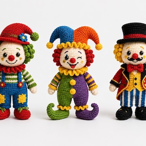 May include: Three handmade crochet dolls featuring clown designs. The left doll wears a red hat and blue overalls. The center doll has a multi-colored jester hat and suit. The right doll wears a black top hat, red jacket, and holds a cane.