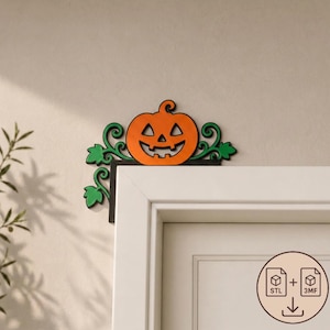 May include: A decorative door corner accent featuring an orange jack-o'-lantern pumpkin with a carved face, surrounded by green swirling vines and leaves. The piece is mounted on a black L-shaped frame designed to fit onto the corner of a door frame.