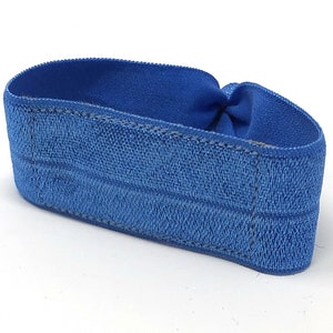 May include: A blue elastic headband with a textured surface.