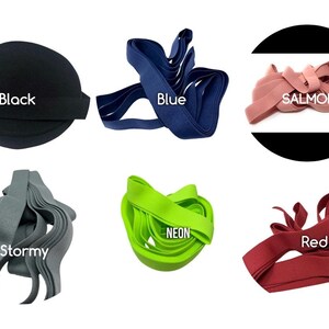 May include: Assortment of elastic bands in various colours, including black, blue, salmon, stormy grey, neon green, and red. The elastic bands are arranged in a circle on a white background.
