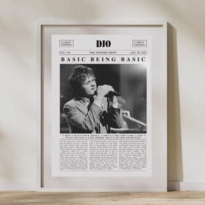 May include: Black and white framed print featuring the text "DJO BASIC BEING BASIC" and a photograph of a person singing into a microphone. The print includes the text "The Tonight Show" and "Jan. 28, 2025".