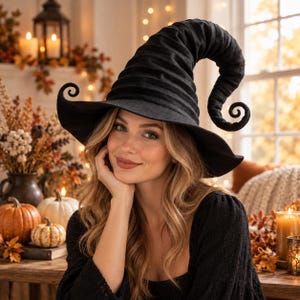May include: A black witch hat featuring a tall, pointed, and curved crown with a wide, curled brim. The hat is constructed from a textured fabric and displays a distinct, spiraling tip that bends downward, creating a classic, pointed silhouette.